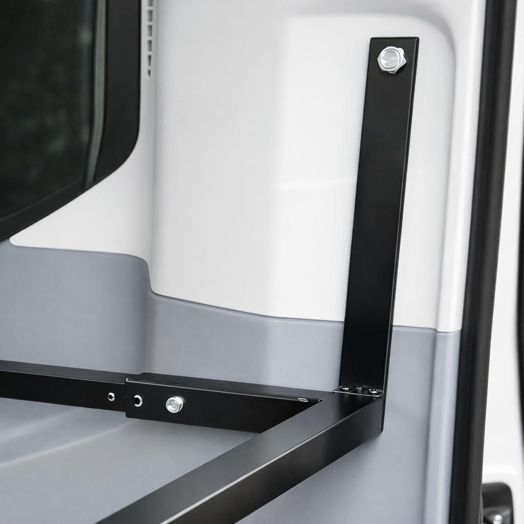 Custom built brackets attached to the rear seatbelt mounting location in a passenger ford transit.  32x55 bed system. 